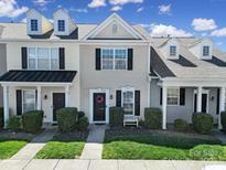 Charming townhome featuring a well-maintained lawn, classic architectural details, and a welcoming entrance at 13376 Calloway Glen Dr, Charlotte, NC 28273