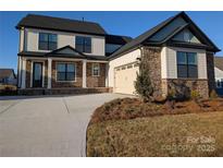 Charming two-story home featuring a stone facade, covered porch, and attached two-car garage at 1939 Hendricks St, Rock Hill, SC 29732