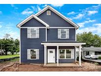 Charming two-story home with blue siding, white trim, and a welcoming front porch on a sunny day at 2628 S Main St, Kannapolis, NC 28027