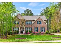 Traditional brick home with blue shutters, landscaped lawn, and mature trees, creating a welcoming curb appeal at 3095 Foggy Hollow Ln, Clover, SC 29710