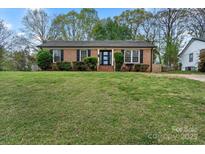 Charming brick home featuring a well-manicured lawn and inviting front entrance at 4932 Delivau Dr, Charlotte, NC 28215