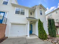 Charming two-story home featuring a one car garage, blue front door, and tasteful landscaping at 6525 Soapstone Dr, Charlotte, NC 28269