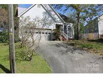 Charming home with an attached garage and an inviting entrance, complemented by a well-maintained driveway at 9915 Lottie Ln, Charlotte, NC 28262