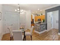 Bright dining area with a glass table and comfortable chairs near the kitchen at 2934 Selwyn Ave, Charlotte, NC 28209