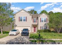 Traditional two-story home featuring neutral siding, red shutters and door, and a two-car attached garage at 3882 Shasta Cir, Clover, SC 29710
