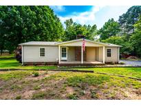 Charming single-story home with brick accents, a well-maintained lawn and an American flag at 7050 Forney Hill Rd, Denver, NC 28037