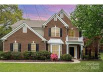 Charming brick home with a manicured lawn and inviting front entrance at 10325 Merlin Meadows Ct, Charlotte, NC 28277