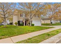 Charming two-story home with manicured lawn and inviting curb appeal at 120 Vermillion Loop, Statesville, NC 28625