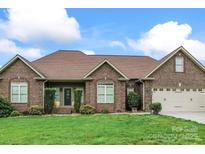 Charming single-story brick home featuring a manicured front lawn and an attached two-car garage at 132 Postell Dr, Statesville, NC 28625