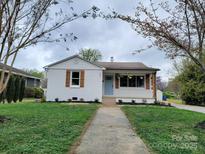 Charming single-story home with a tidy front lawn and inviting light blue entry door at 1421 Van Nuys St, Salisbury, NC 28144