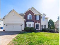 Charming two-story home featuring a well-manicured lawn and attached two-car garage at 20132 Tailwind Ln, Cornelius, NC 28031
