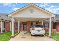 Inviting brick home featuring a covered carport and well-maintained lawn, perfect for comfortable living at 3921 Sage Ct, Denver, NC 28037