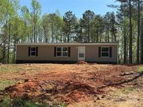 Newly constructed single-story home featuring neutral siding and a wooded lot, ready for landscaping at 43300 Isen Rd, New London, NC 28127