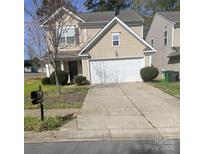 Charming two-story home with a two car garage, manicured lawn, and a traditional mailbox at 4831 Belmar Place Rd, Charlotte, NC 28269