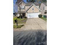 Traditional two-story home boasts an attached two-car garage and well-manicured landscaping at 4831 Belmar Place Rd, Charlotte, NC 28269