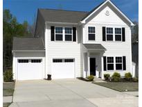 Charming two-story home features a two-car garage, well-maintained lawn, and classic architectural details at 5109 Arbordale Way, Mount Holly, NC 28120