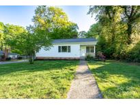Charming home featuring a well-maintained lawn and inviting walkway up to the front door at 676 Forest Nw St, Concord, NC 28025