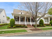 Charming home featuring a welcoming front porch, well-manicured lawn, and classic architectural details at 9514 Wheatfield Rd, Charlotte, NC 28277