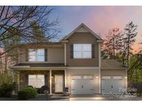 Charming two-story home with stone accents, covered porch, and attached two-car garage at 1248 Century Dr, Clover, SC 29710