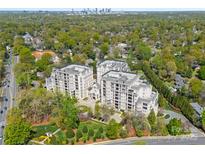 Stunning aerial view of luxurious condos surrounded by lush greenery, with Charlotte skyline in the distance at 2823 Providence Rd # 143, Charlotte, NC 28211