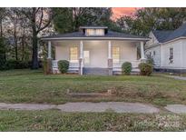 Beautiful home with covered porch, perfect for enjoying outdoor living and serene neighborhood views at 319 Chestnut St, Rock Hill, SC 29730