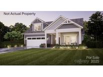 Charming two-story home with a manicured lawn, inviting porch, and integrated two-car garage at 39 Five Creek Rd # 39, Charlotte, NC 28213