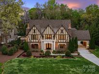 Charming Tudor-style home showcasing architectural details and manicured landscaping at 4400 Sharon View Rd, Charlotte, NC 28226