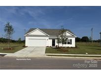 Charming single-story home with a two-car garage, well-manicured lawn, and inviting curb appeal at 6215 Honor Ave, Midland, NC 28107