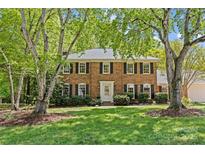 Charming brick two-story home with black shutters and a well-manicured front lawn at 9607 Stoney Hill Ln, Charlotte, NC 28277