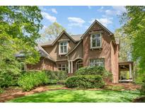 Charming brick home with manicured lawn and mature landscaping offers classic curb appeal at 1116 Landons Ct, China Grove, NC 28023