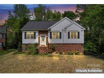 Charming two-story home with brick accents, black shutters, and inviting landscaped front yard at 12822 Diamond Dr, Pineville, NC 28134