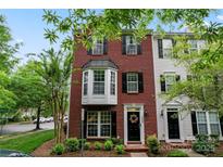Charming brick townhome featuring a black door with decorative wreath, and black shutters at 12905 Bullock Greenway Blvd, Charlotte, NC 28277