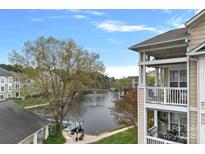 Scenic exterior view from the balcony overlooking a serene lake and a pier for waterfront enjoyment at 18742 Nautical Dr # 301, Cornelius, NC 28031