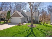 Charming single-Gathering home with a well-maintained lawn, attached garage, and appealing neutral-toned exterior at 2532 Annecy Dr, Matthews, NC 28105