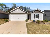 Charming single-story home with a well-maintained lawn, a two-car garage and welcoming curb appeal at 3118 Maple Ridge Dr # 11, Gastonia, NC 28052
