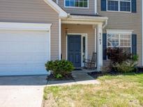 Inviting front entrance with a rocking chair and neat landscaping, adjacent to the garage at 5102 Candleglow Ct, Indian Trail, NC 28079