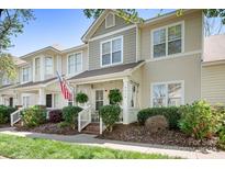 Inviting two-story townhouse with a cozy porch and well-maintained landscaping at 7910 Camden Hollow Rd, Huntersville, NC 28078