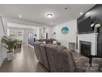 Open-concept living room featuring a fireplace and seamless access to the kitchen at 1245 Pebble Grove Dr, Clover, SC 29710