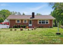 Charming one-story brick home featuring a well-maintained front yard and a cozy, inviting facade at 175 Neita Dr, Salisbury, NC 28147