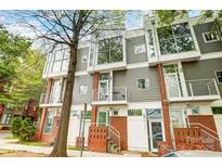 Modern townhome with gray siding, brick accents, and large windows at 2094 Euclid Ave, Charlotte, NC 28203