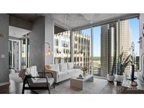 Bright living room with floor-to-ceiling windows and cityscape views at 210 N Church St # 3507, Charlotte, NC 28202
