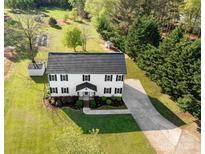 An aerial view of a beautiful home with a large yard, mature trees, and a long driveway at 311 Cooks Lake Rd, Gastonia, NC 28056