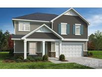 Charming two-story home with a two-car garage, and classic architecture on a landscaped lawn at 3244 Maya Ln # 44, Midland, NC 28107