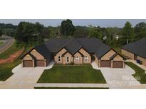 A beautiful, newly constructed brick home with two-car garages and a well-manicured lawn at 3345 48Th Ne Ave # 16A, Hickory, NC 28601