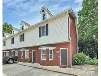 Charming townhome featuring brick and siding exterior with dormer windows and well-maintained landscaping at 405 N Wilson St # 101, Rock Hill, SC 29730