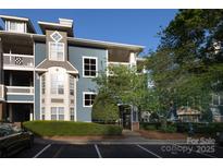 Charming blue condo with balconies, complemented by mature trees and professional landscaping at 501 Olmsted Park Pl # N, Charlotte, NC 28203