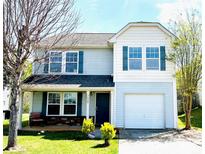 Charming two-story home featuring a covered porch, attached garage, and well-maintained lawn at 7928 Ponderosa Pine Ln, Charlotte, NC 28215