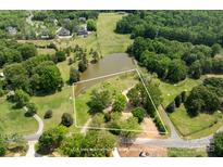 Expansive aerial view of lot with pond; lot lines are approximate, please refer to survey at 8805 Wingard Dr, Waxhaw, NC 28173