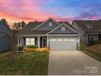Charming single-Gathering home with a well-manicured lawn and inviting curb appeal, perfect for modern living at 224 Old Harbor Dr, Mount Gilead, NC 27306