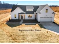 Charming white two-story home with a black roof, two-car garage, and inviting front porch at 295 Laurel Ridge Rd # 7, Lincolnton, NC 28092